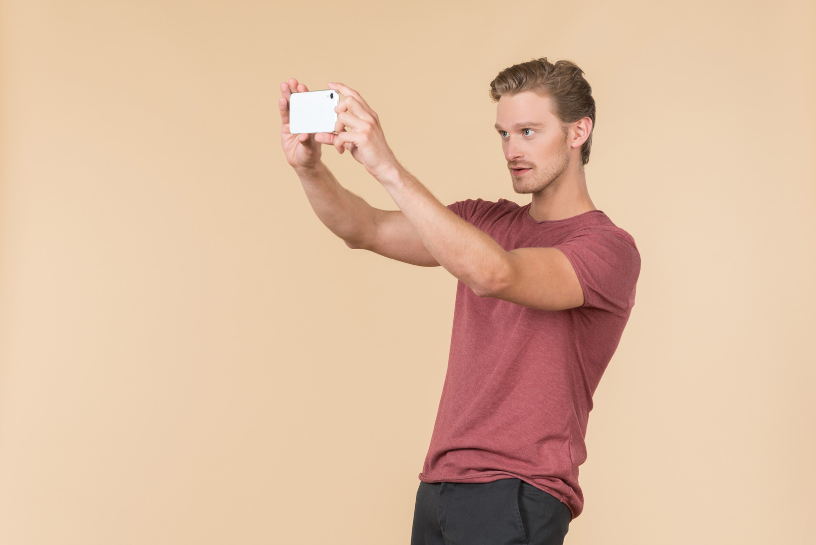 Young guy making a photo with a phone