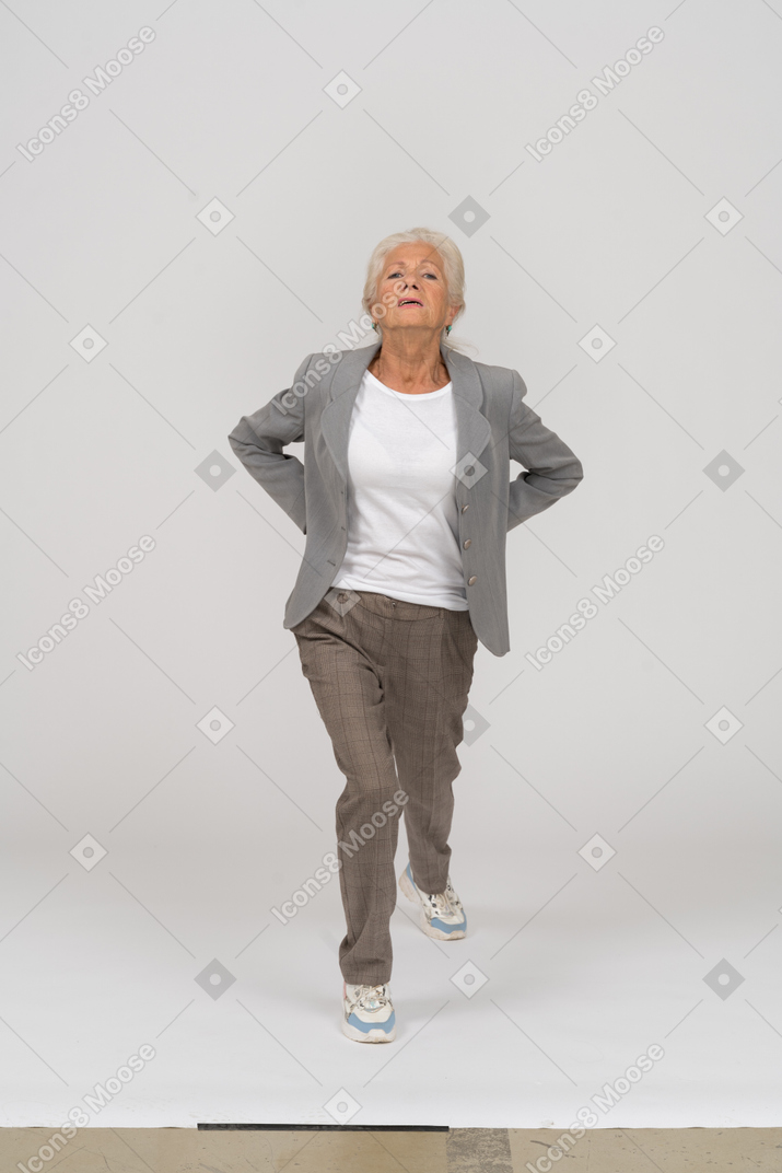 Vista frontal de una anciana en traje haciendo yoga