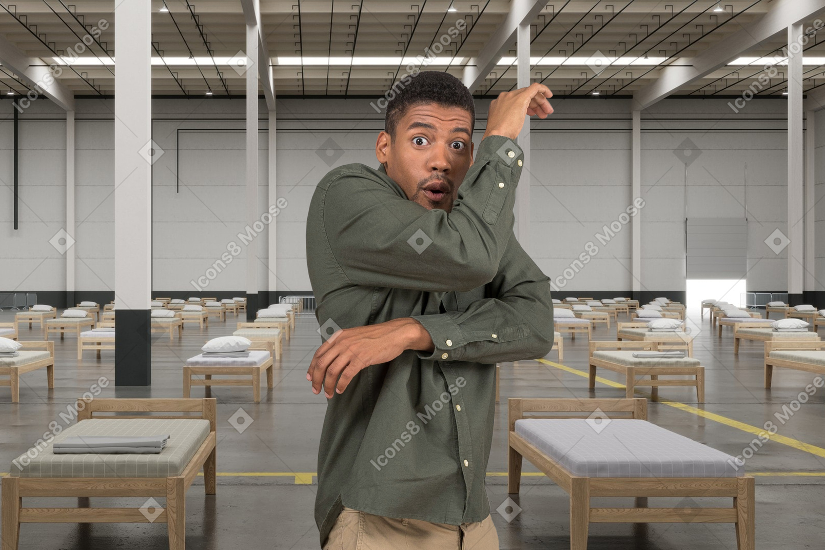 A shocked man standing in a room with beds