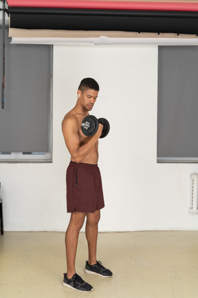 Young man doing dumbbell exercises