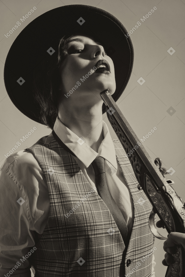 Woman holding breath with the rifle next to her face
