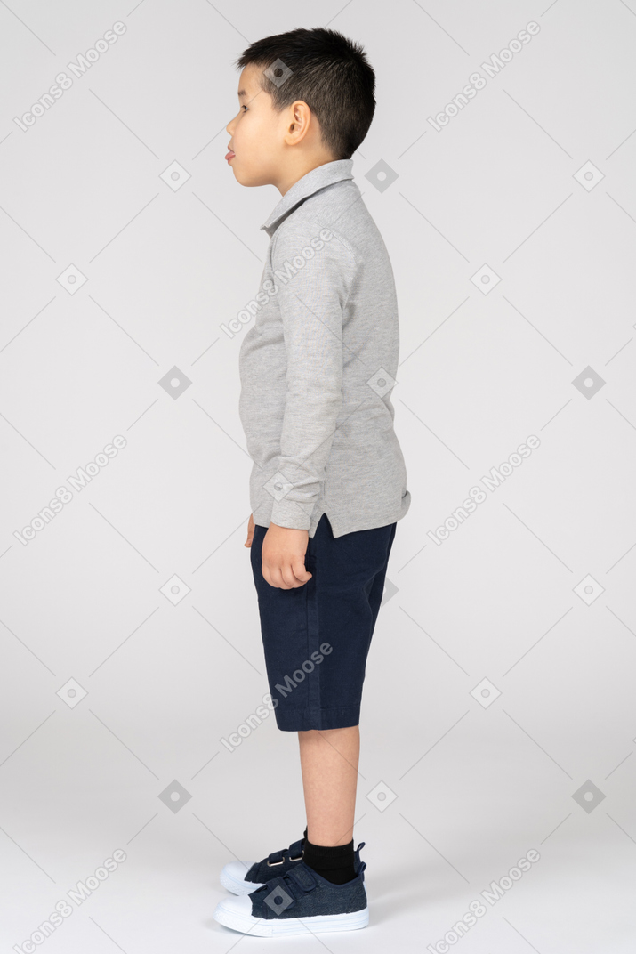 Kid standing in profile