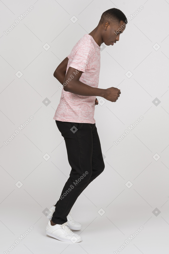Side view of a young man jogging