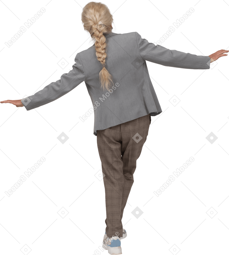 Back view of an old lady in suit standing with outstretched arms