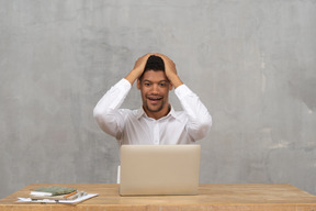 Young man covering his head