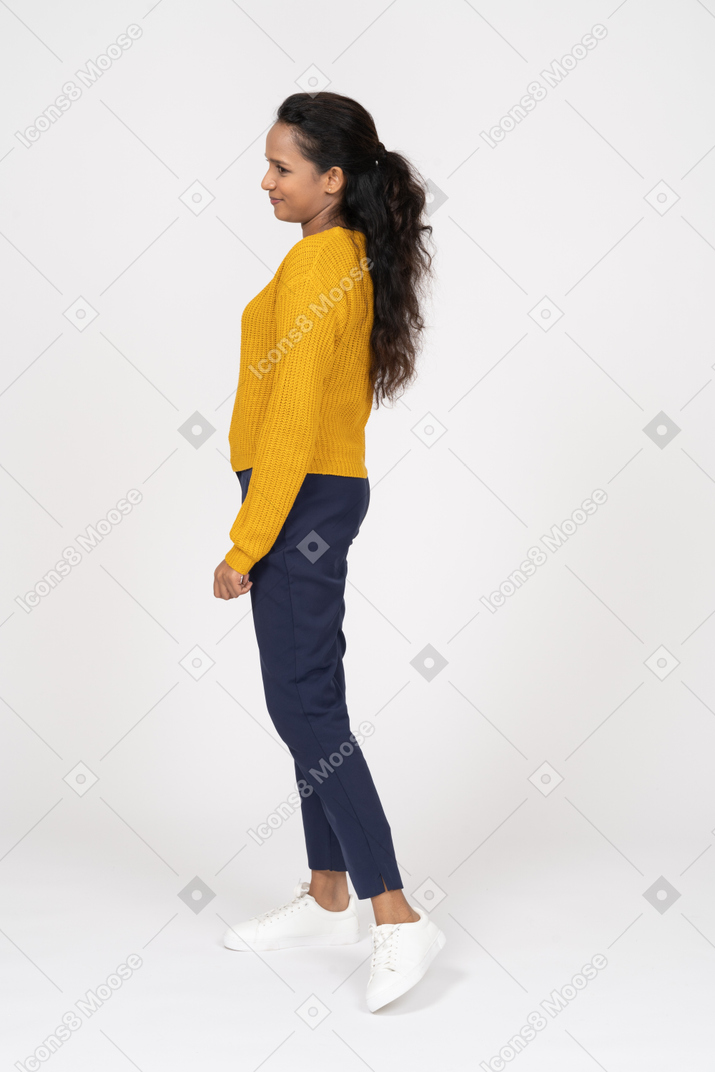 Side view of a cute girl in casual clothes