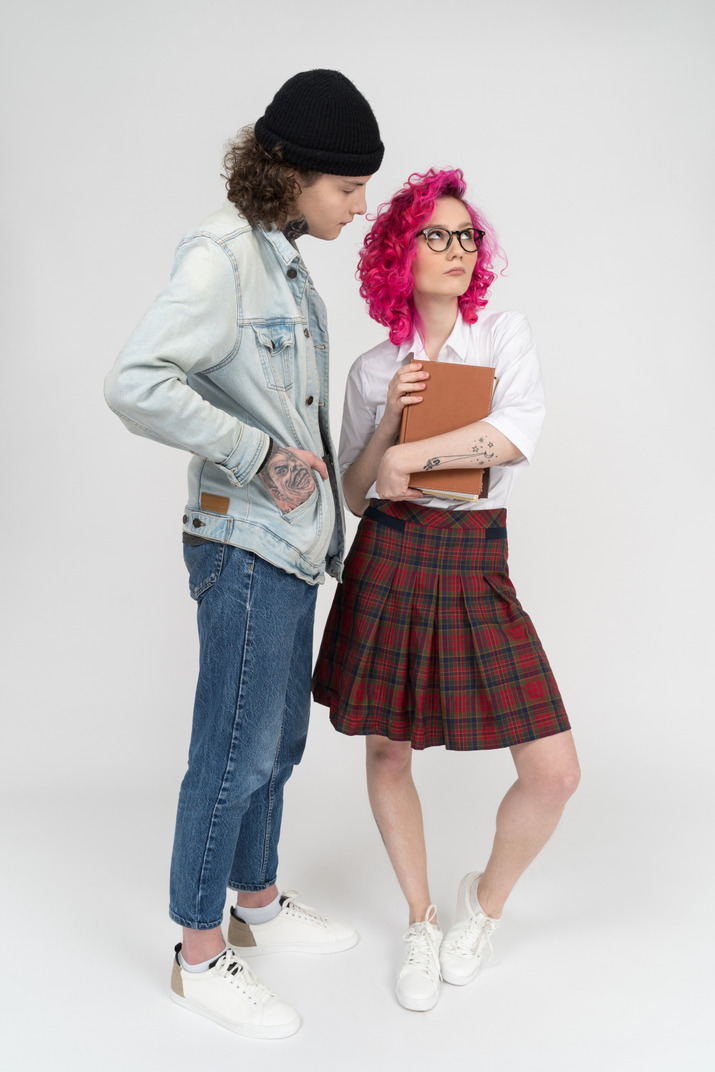 Cute oink-haired female wearing glasses with a teen male standing next to her