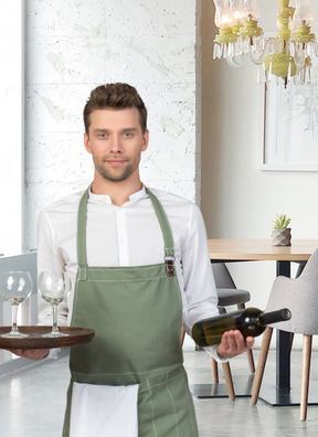A waiter holding a bottle of wine and pair of glasses on a tray