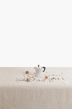 Coffee maker and coffee beans on the table
