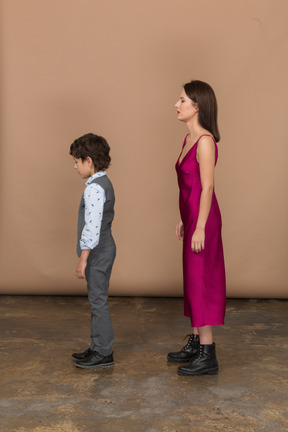 Boy and young woman standing in profile