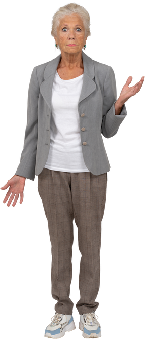 Front view of an old woman in suit looking at camera and gesturing