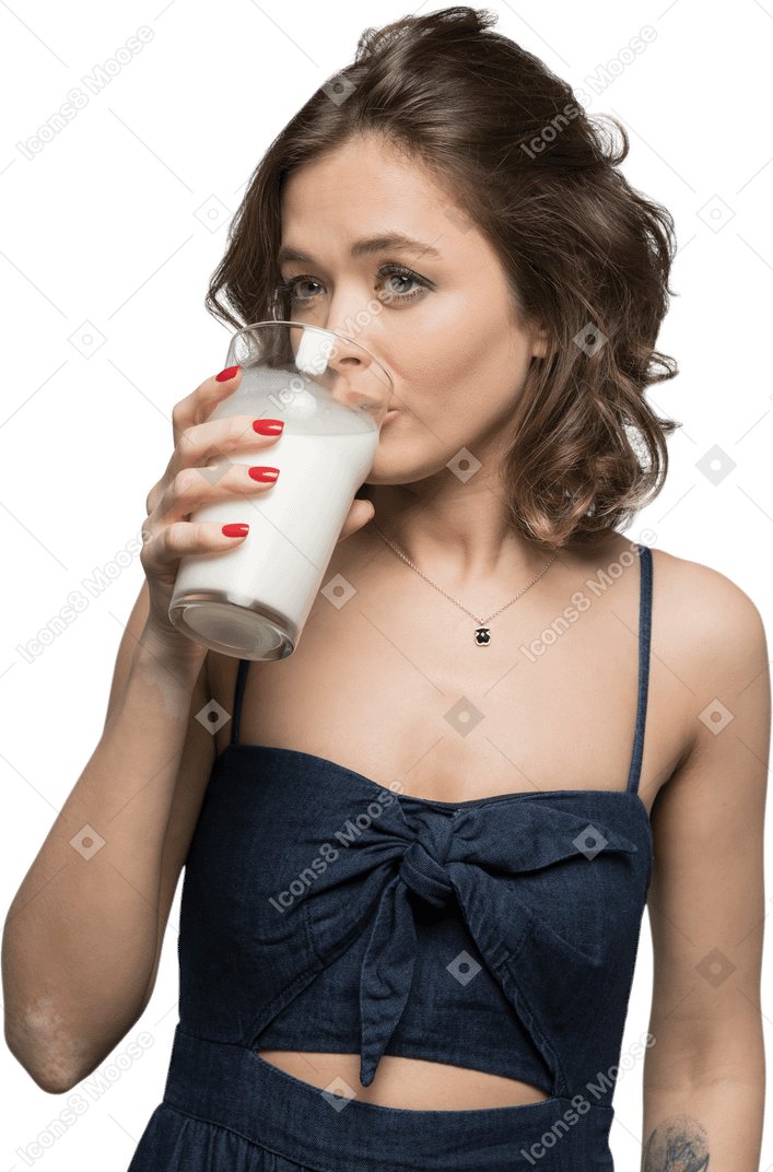 Cute young woman sipping milk