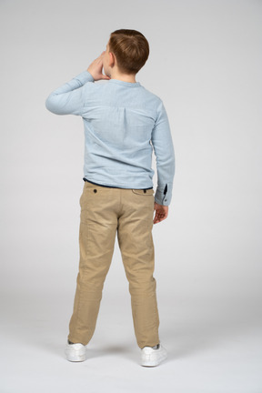 Back view of a boy calling someone