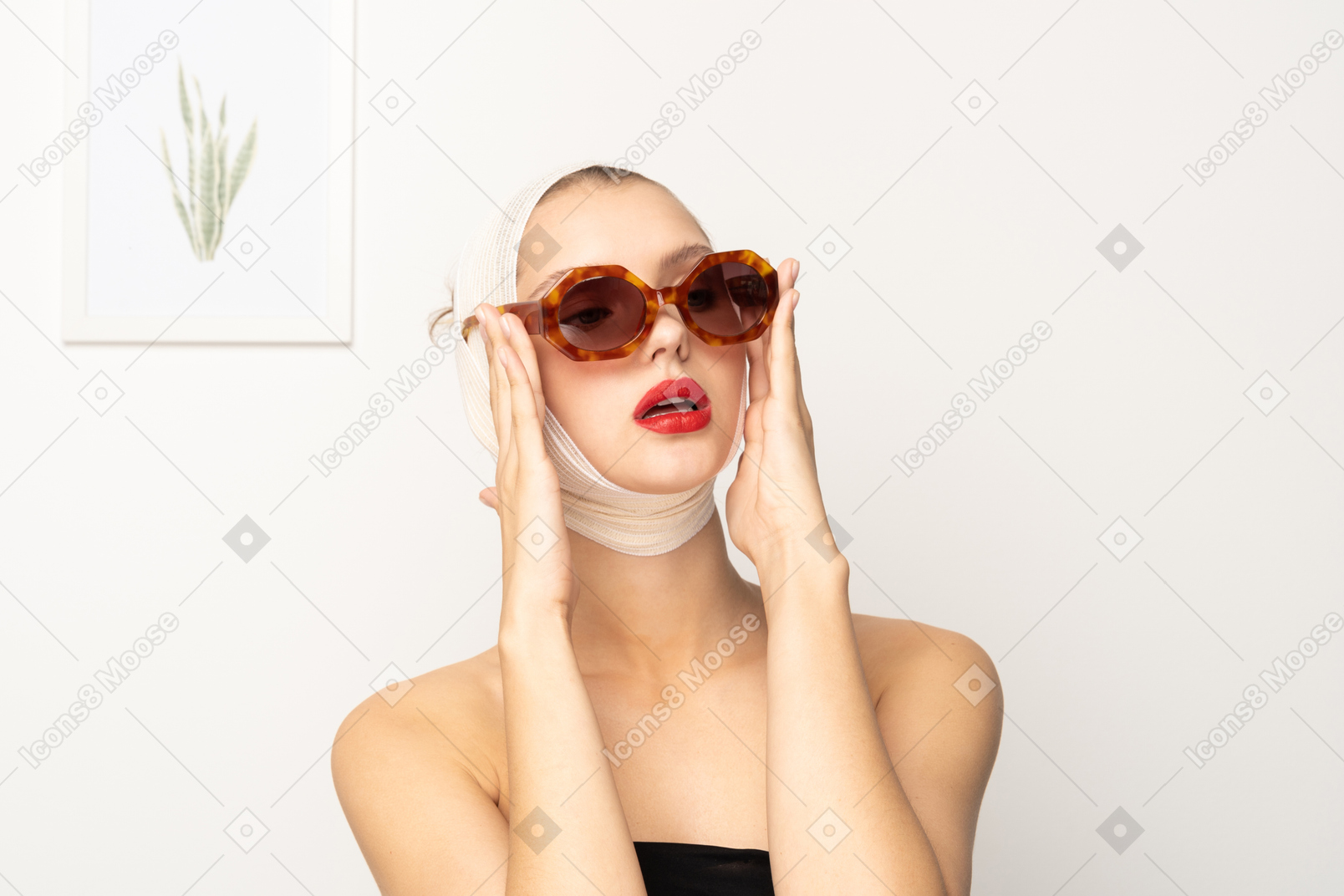 Young woman with head bandage wearing sunglasses