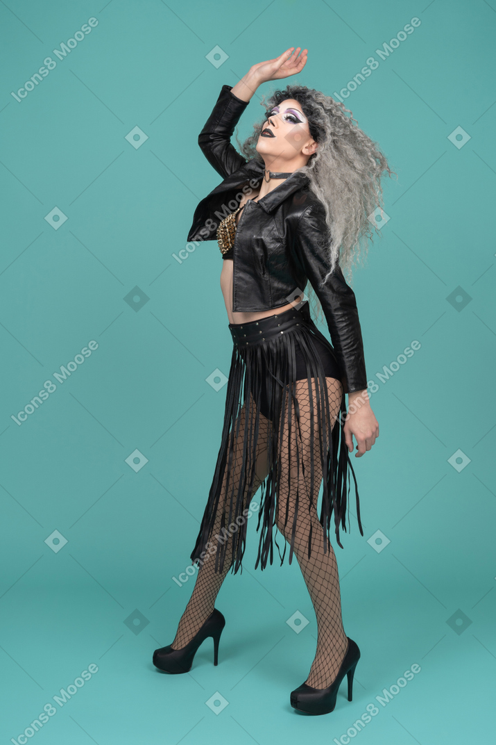 Drag queen in all black outfit striking a dramatic pose