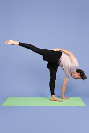 Guy standing in half moon pose