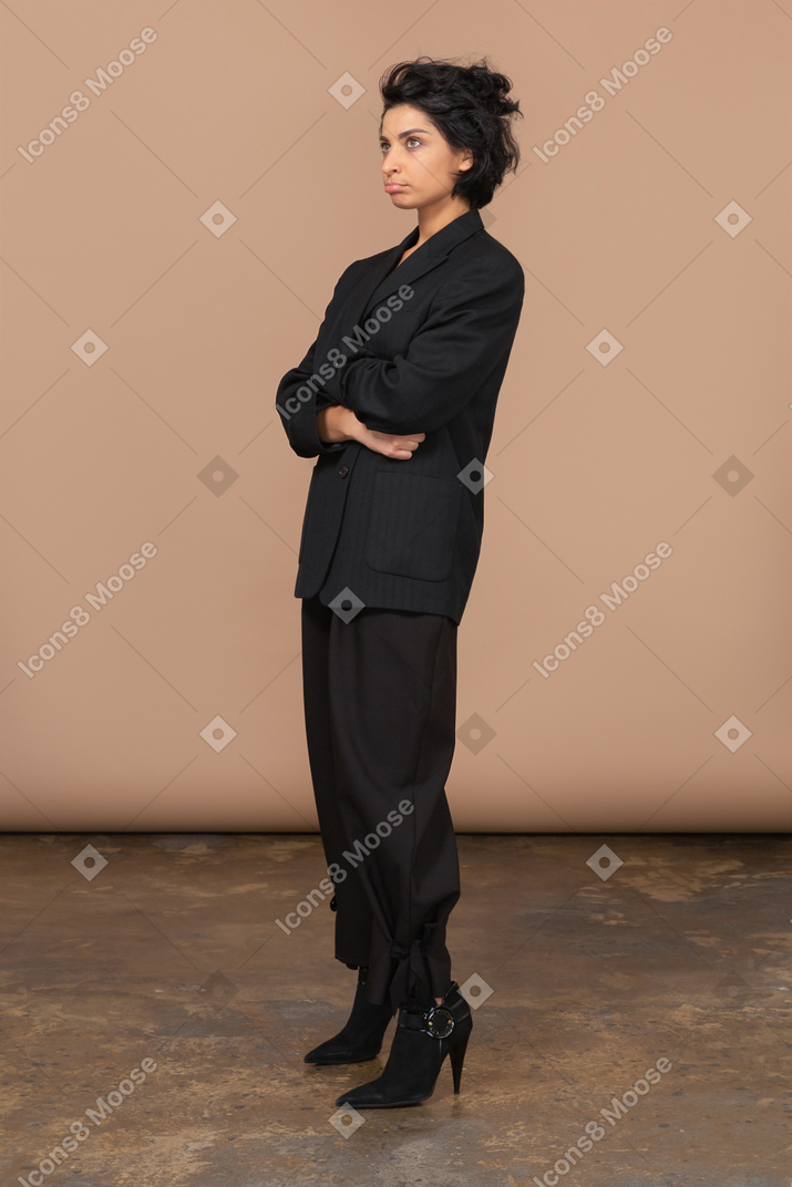 Three-quarter view of a pouting businesswoman dressed in black suit