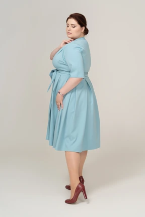 Woman in blue dress posing in profile