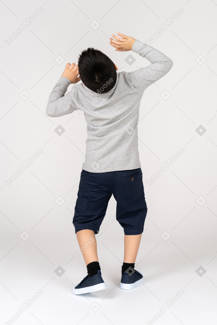 Rear view of a boy leaning back