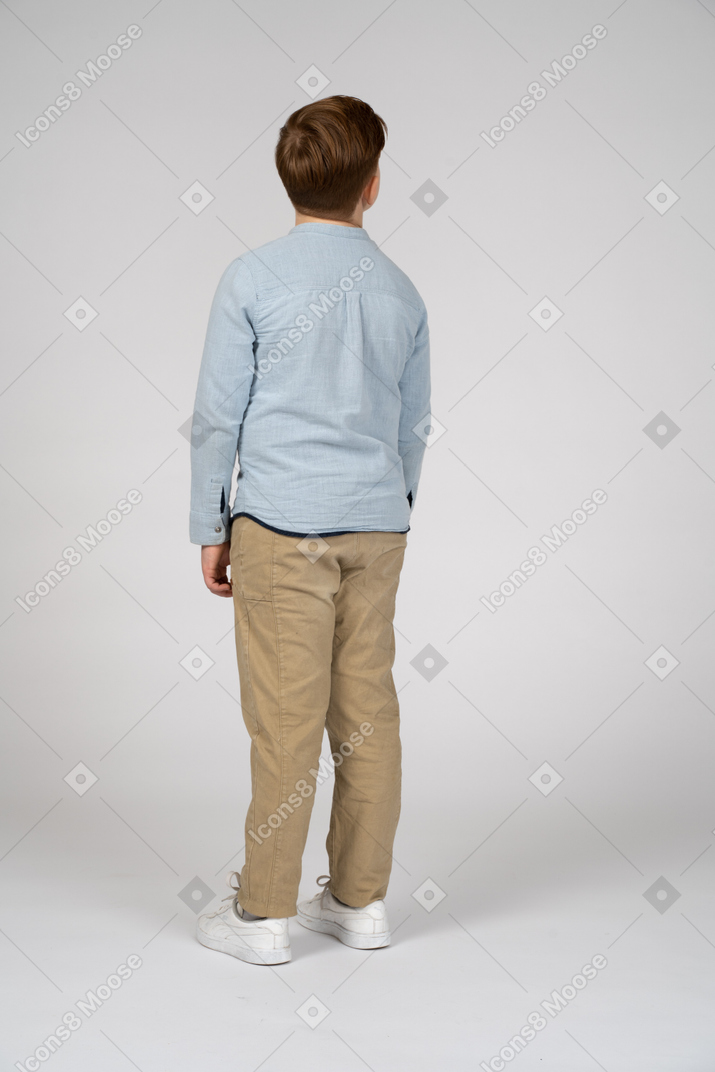 一个穿着休闲服的男孩抬头仰望的背影
