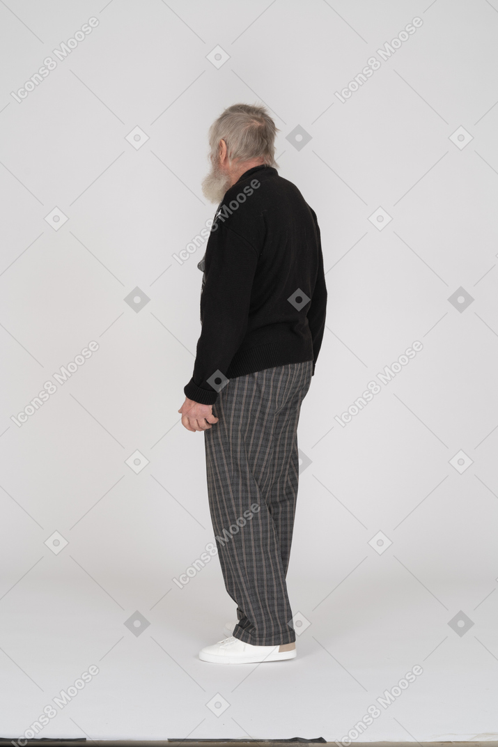 Elderly man in black sweater standing