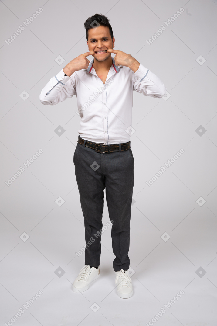 A man in a white shirt making a face