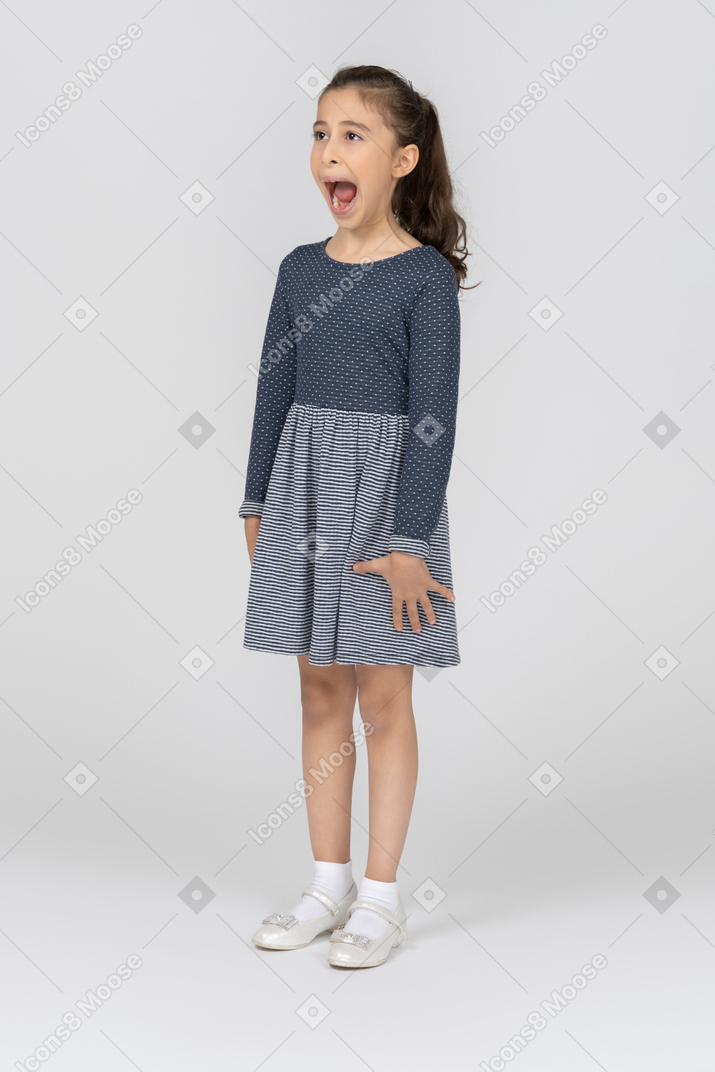 Three-quarter view of a girl yawning wide