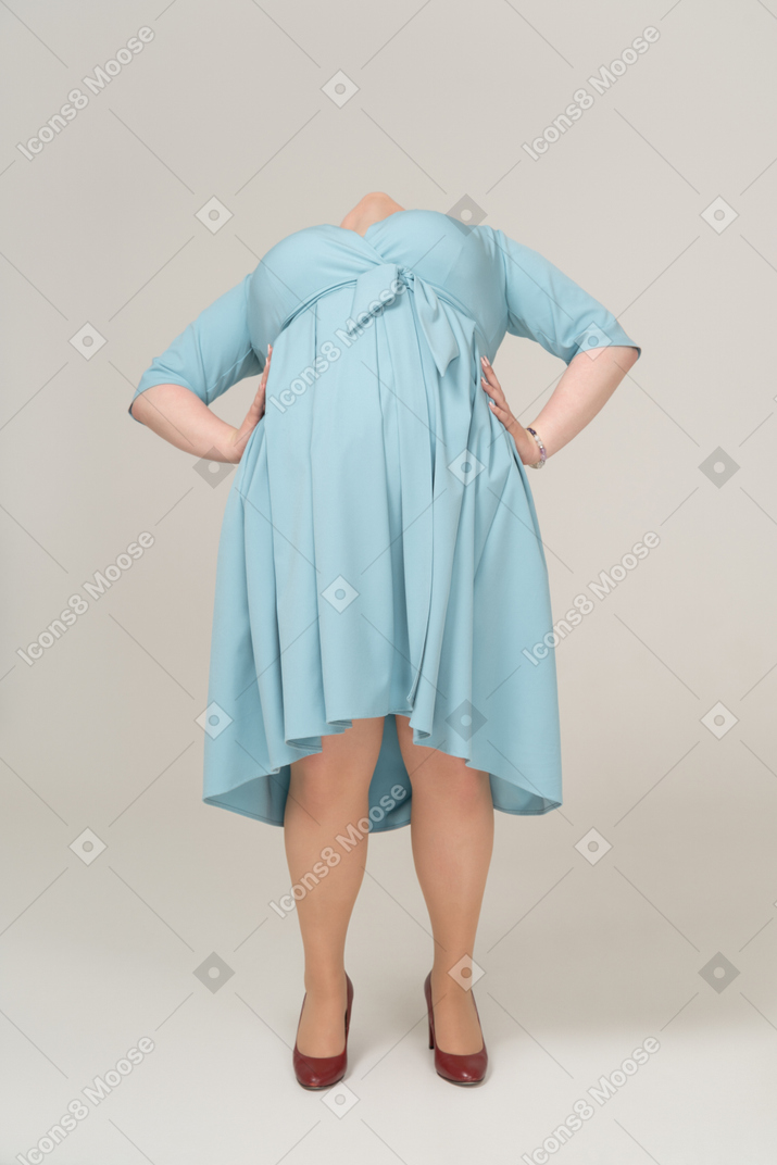 Front view of a woman in blue dress leaning back