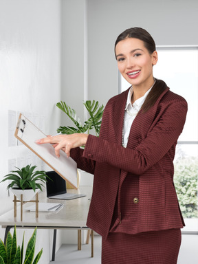A woman in a business suit holding a clipboard