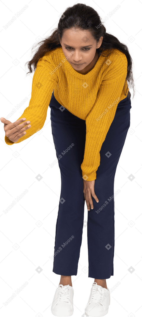 Front view of a girl in casual clothes bending down and explaining something