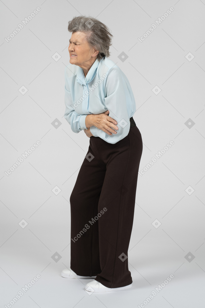 Old woman having stomach ache