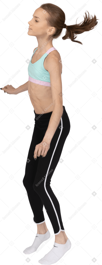 Side view of a teen girl in sportswear dancing