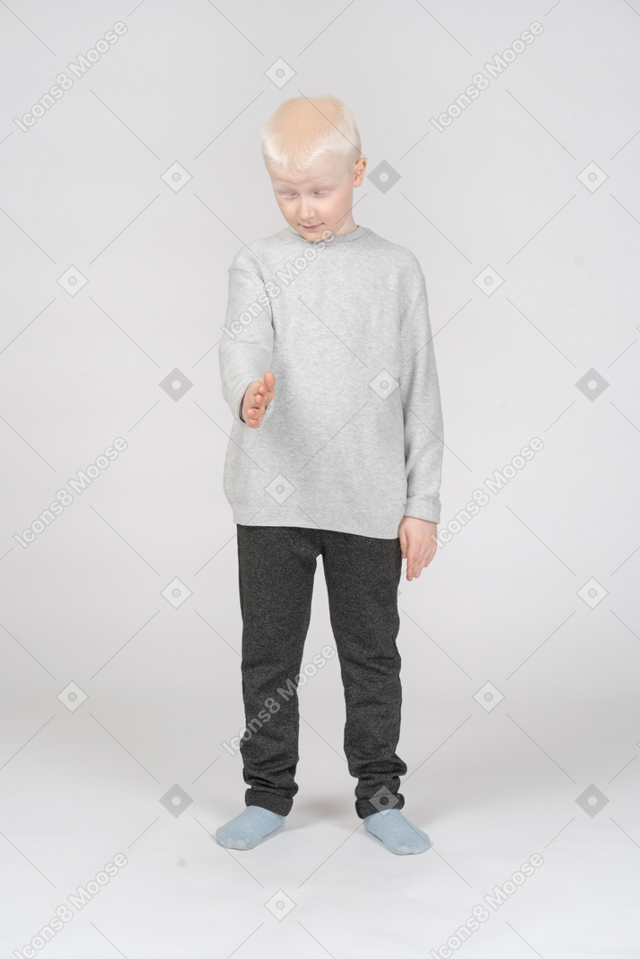 Little boy with closed eyes outstretching his arm