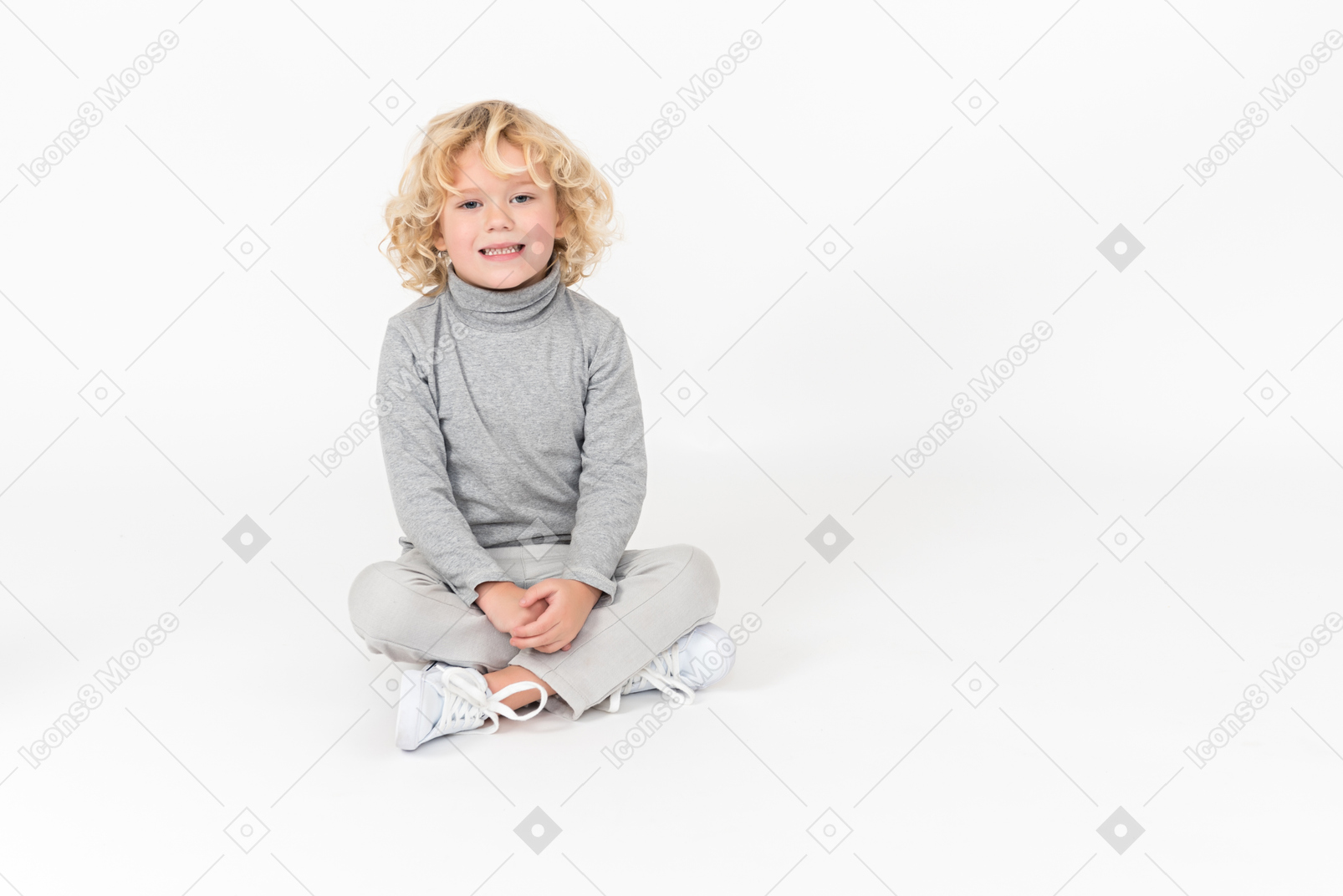 Cute kid boy smiling and sitting on the floor