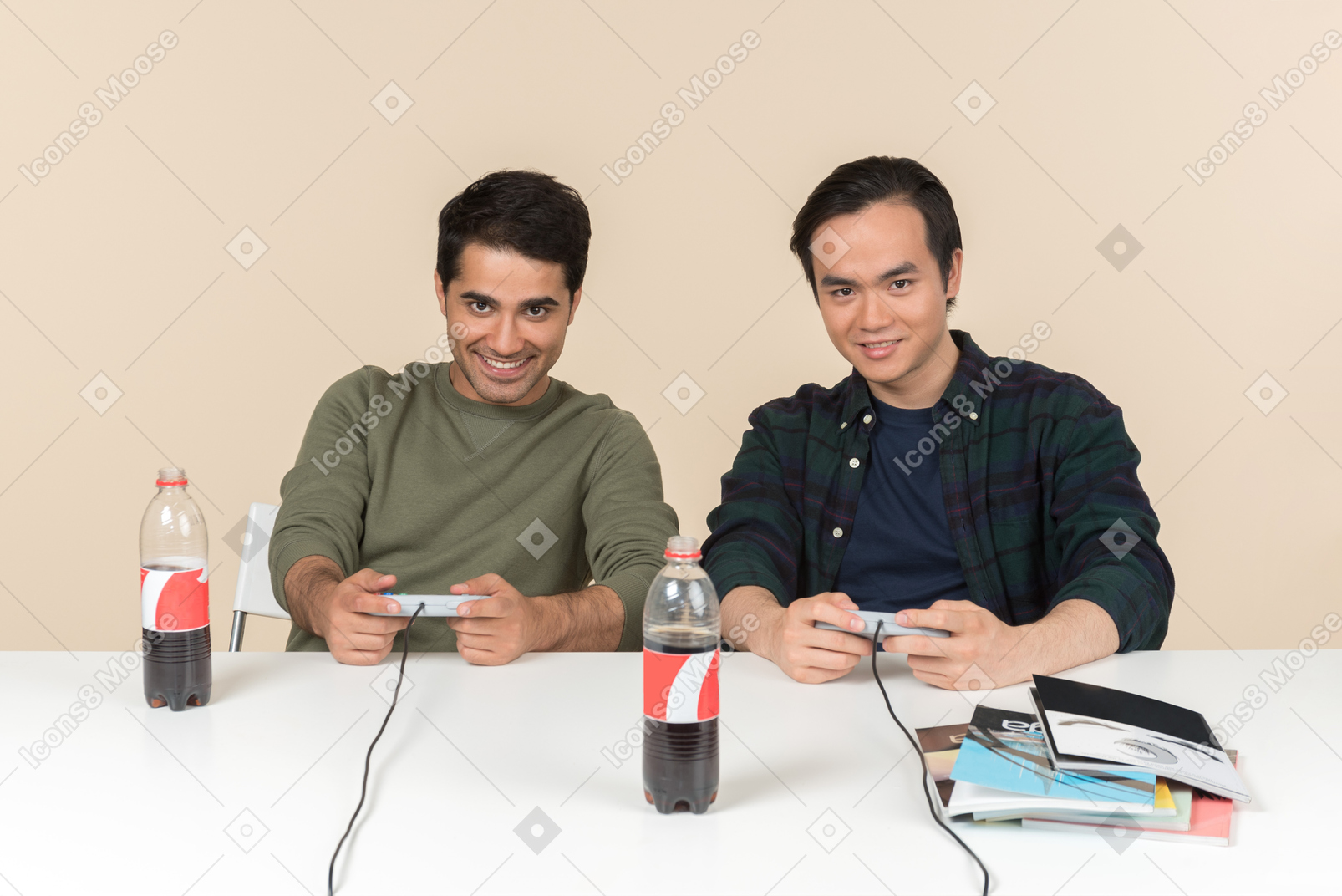 Interracial friends sitting at the table and playing video game