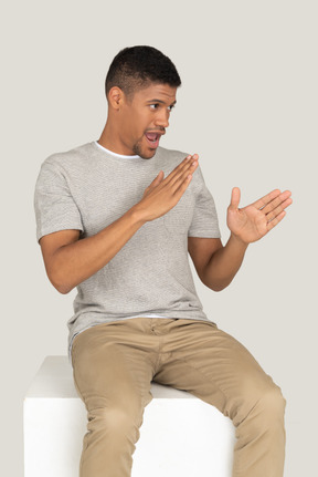 Cute beautiful guy sitting and posing