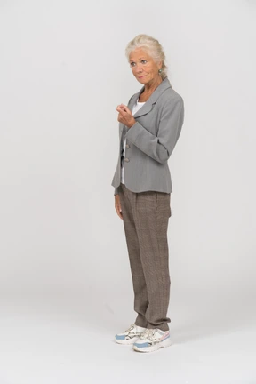 Side view of an old lady in suit asking to come closer