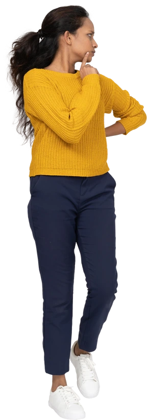 Front view of a thoughtful girl in casual clothes posing with hand on hip