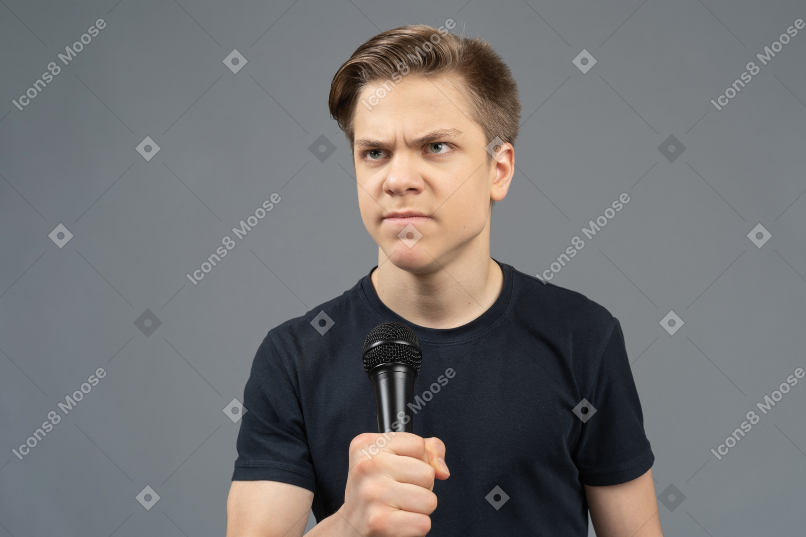 Angry young man holding microphone