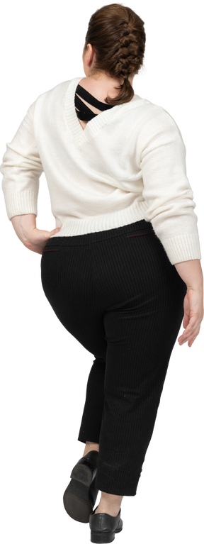 Plus size woman in white sweater posing