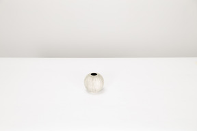 Empty white vase on white table