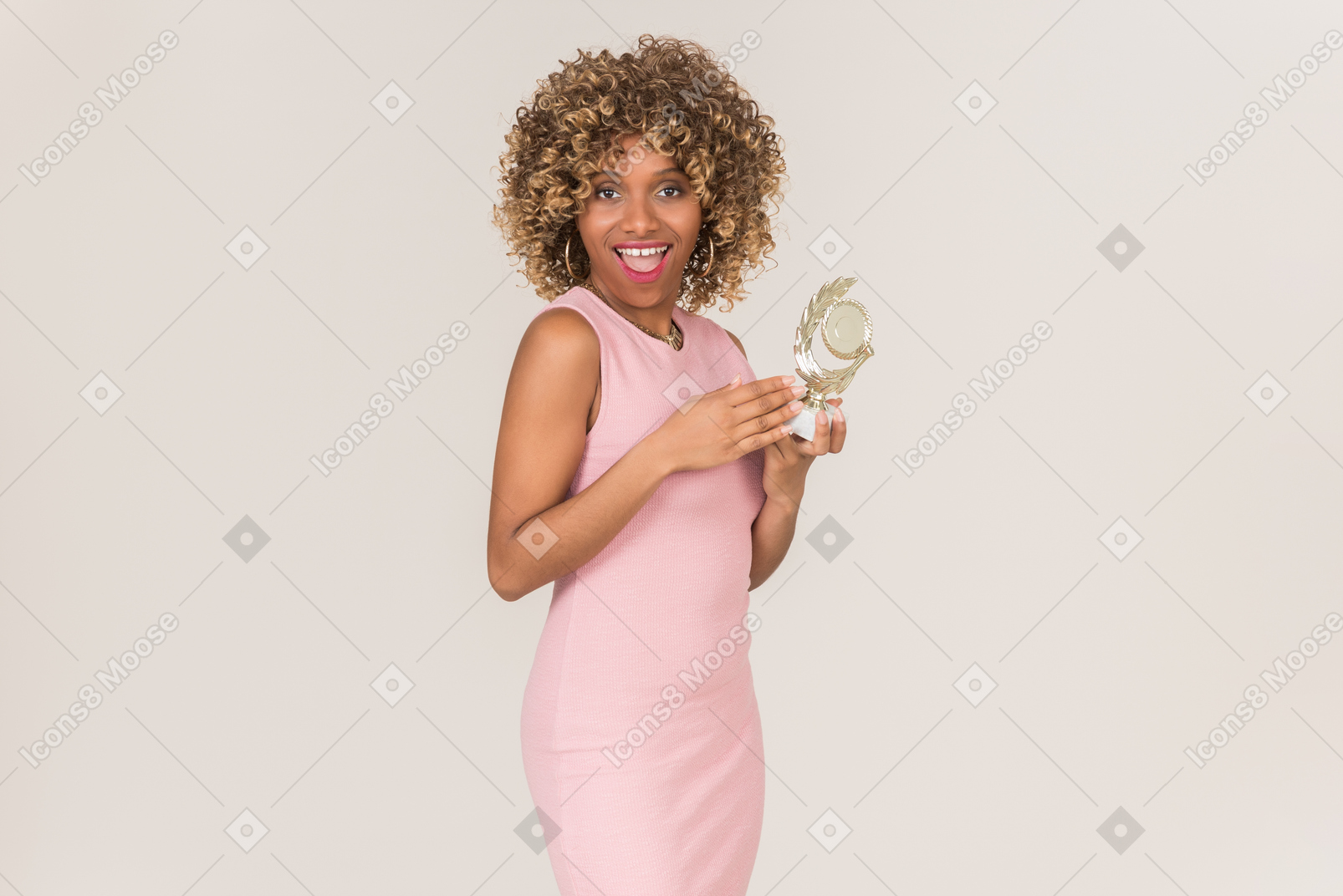 A woman in pink standing with an award