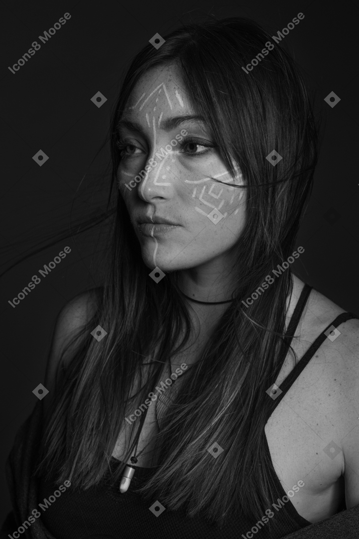 Monochrome photo of woman with ethnic pattern on her face