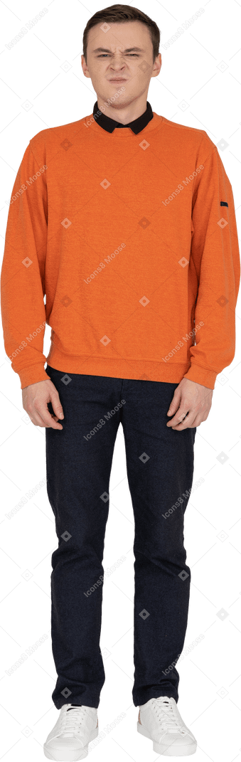 Young man in orange sweatshirt standing