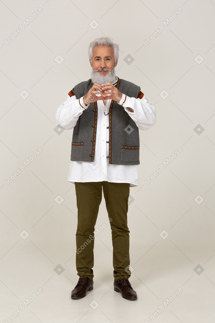 Smiling man making a hand heart