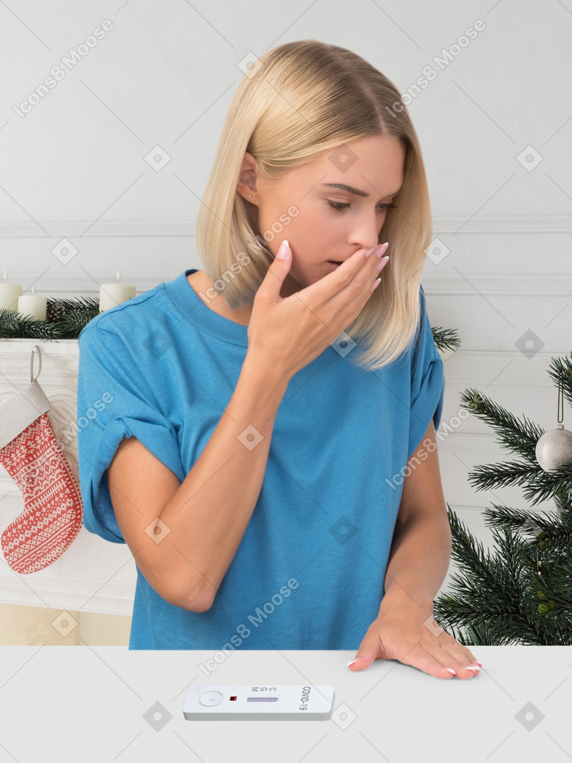 Woman anxious about pregnancy in front of christmas tree