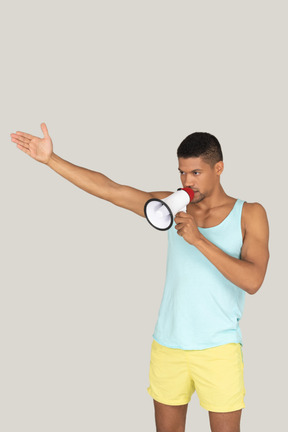 A lifeguard man talking into a loudspeaker