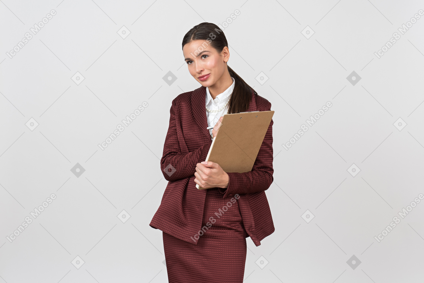 Attractive formally dressed woman taking notes on a clipboard