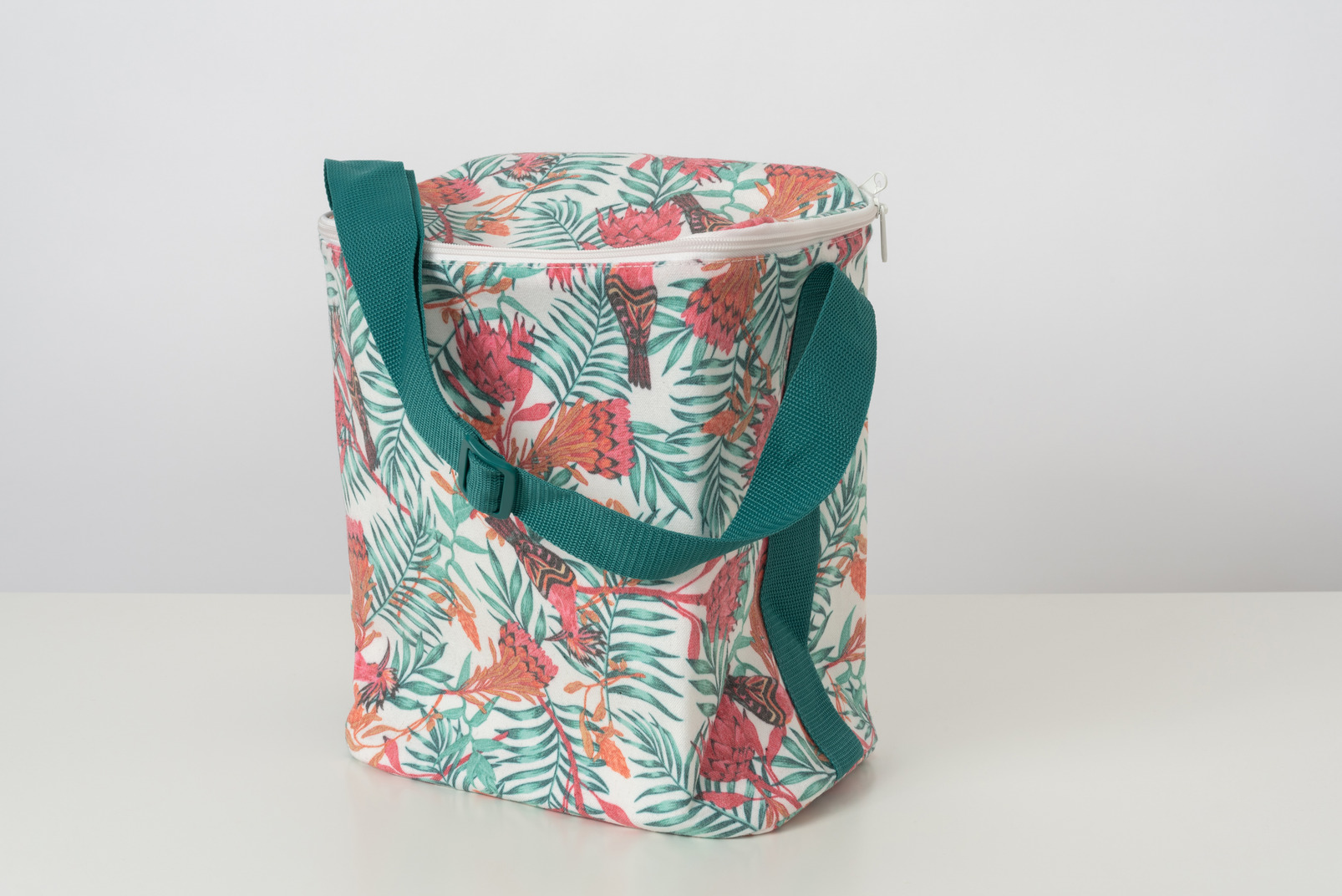 A summer thermal lunch bag with printed plants and butterflies on it