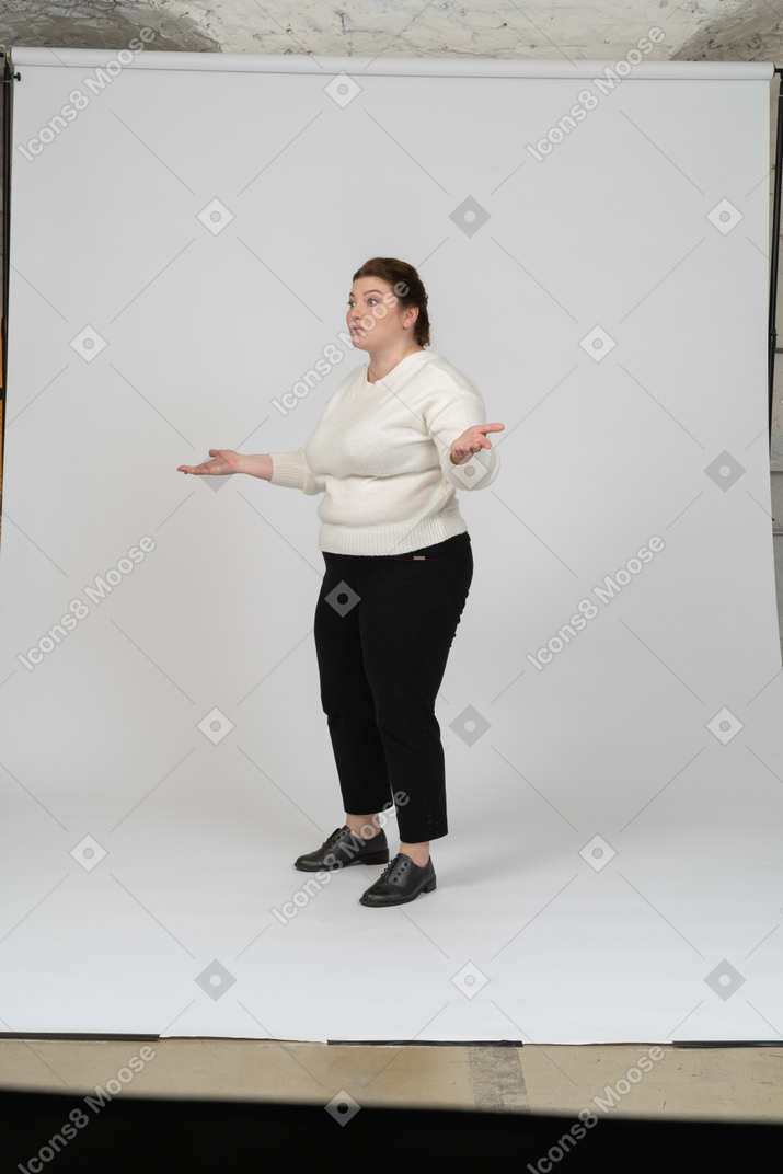 Side view of a plump woman in casual clothes gesturing